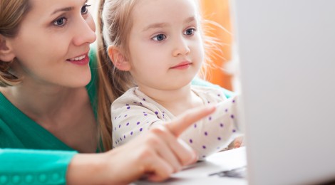 mom and daughter using laptop