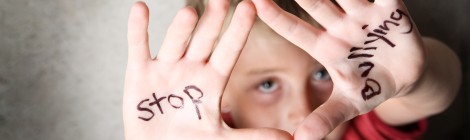 boy with "stop bullying" written on his hands